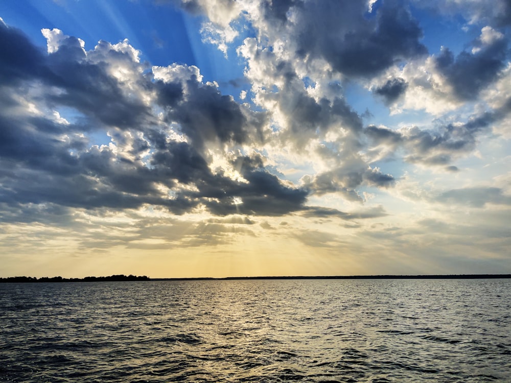 a large body of water under a cloudy sky