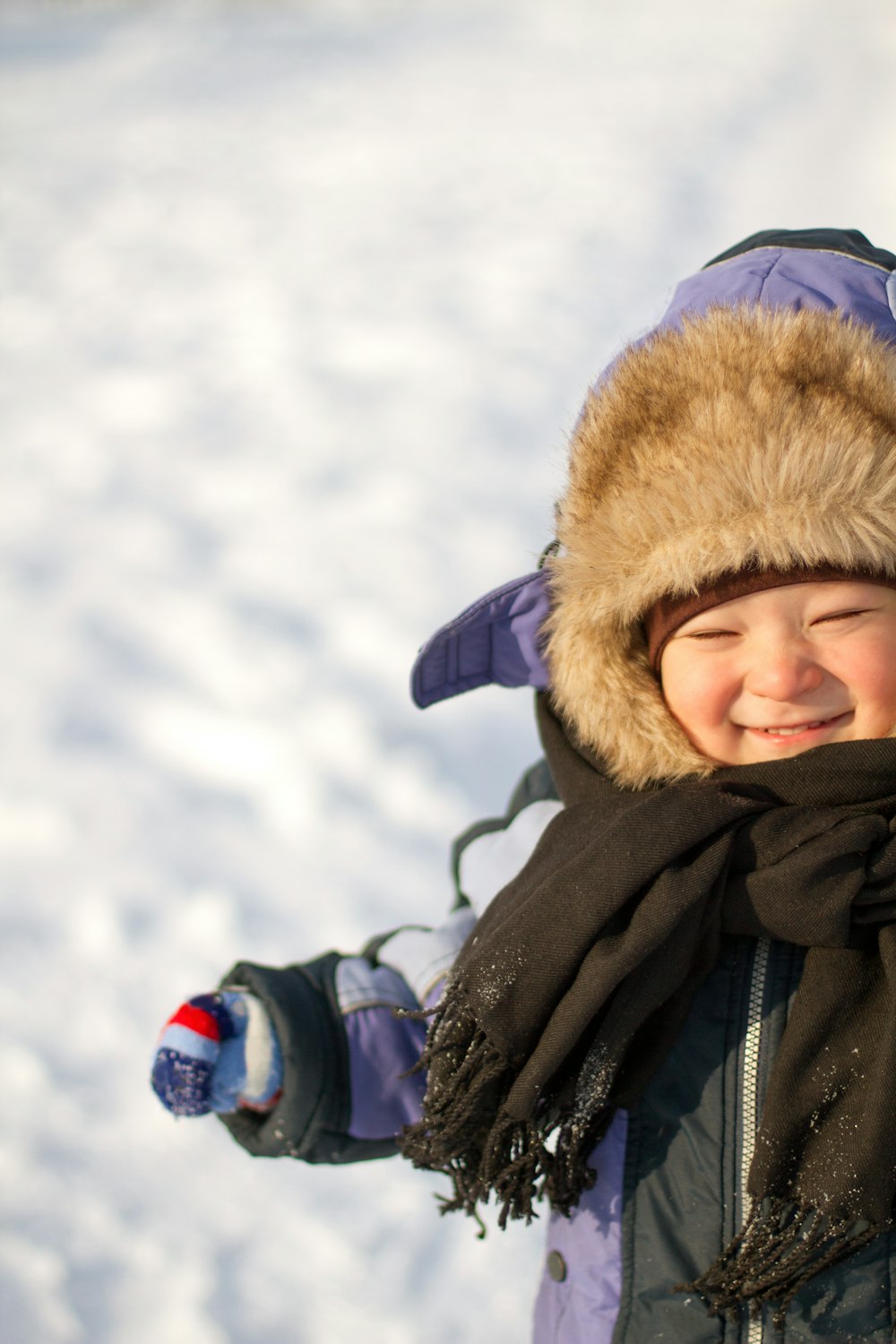 a young child wearing a winter hat and scarf