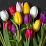 a bunch of colorful tulips in a vase