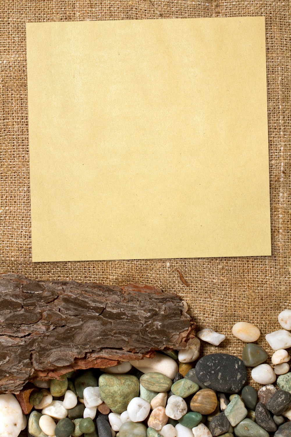 a piece of paper sitting on top of a pile of rocks