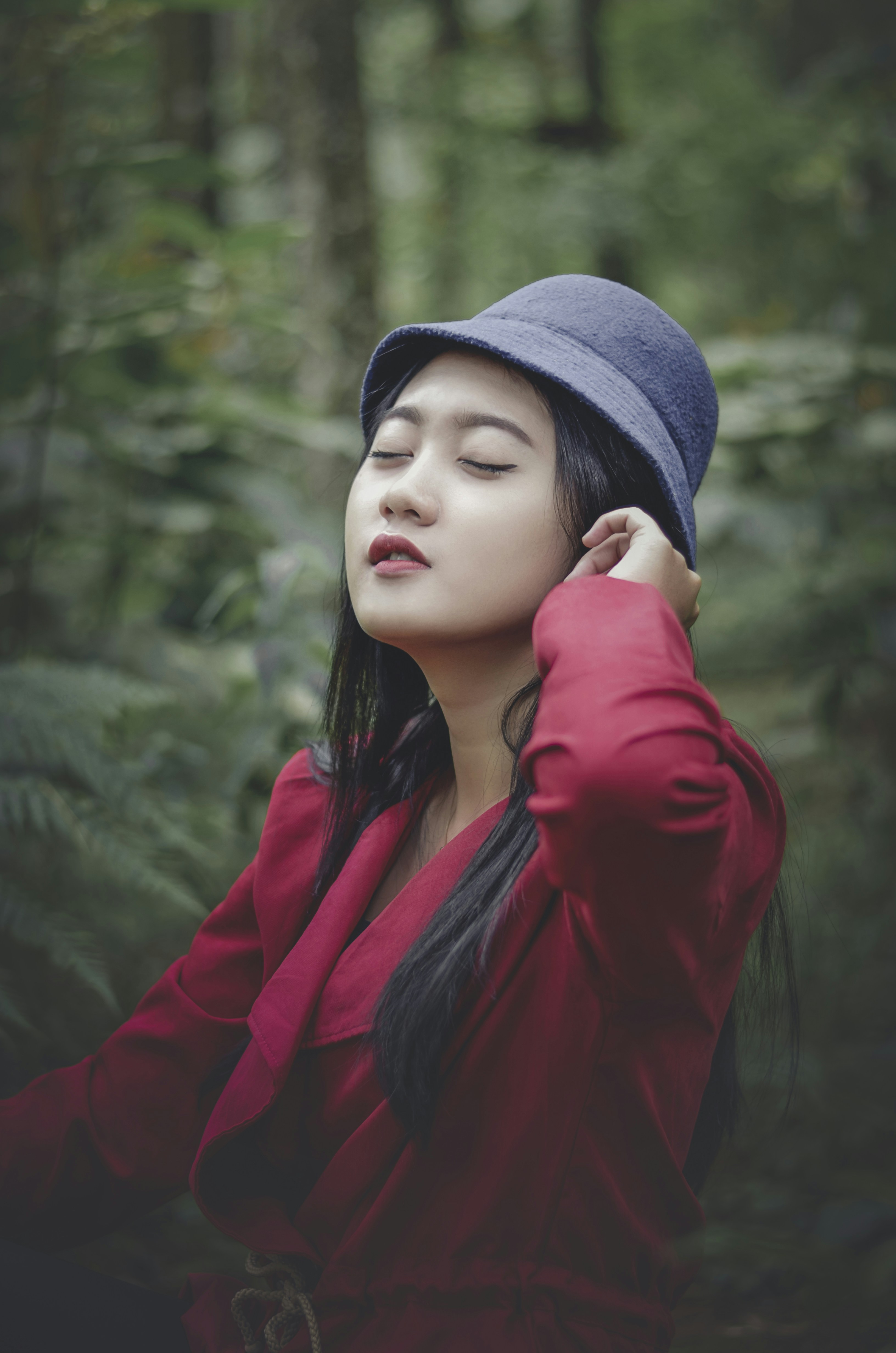 a woman in a red shirt and a blue hat