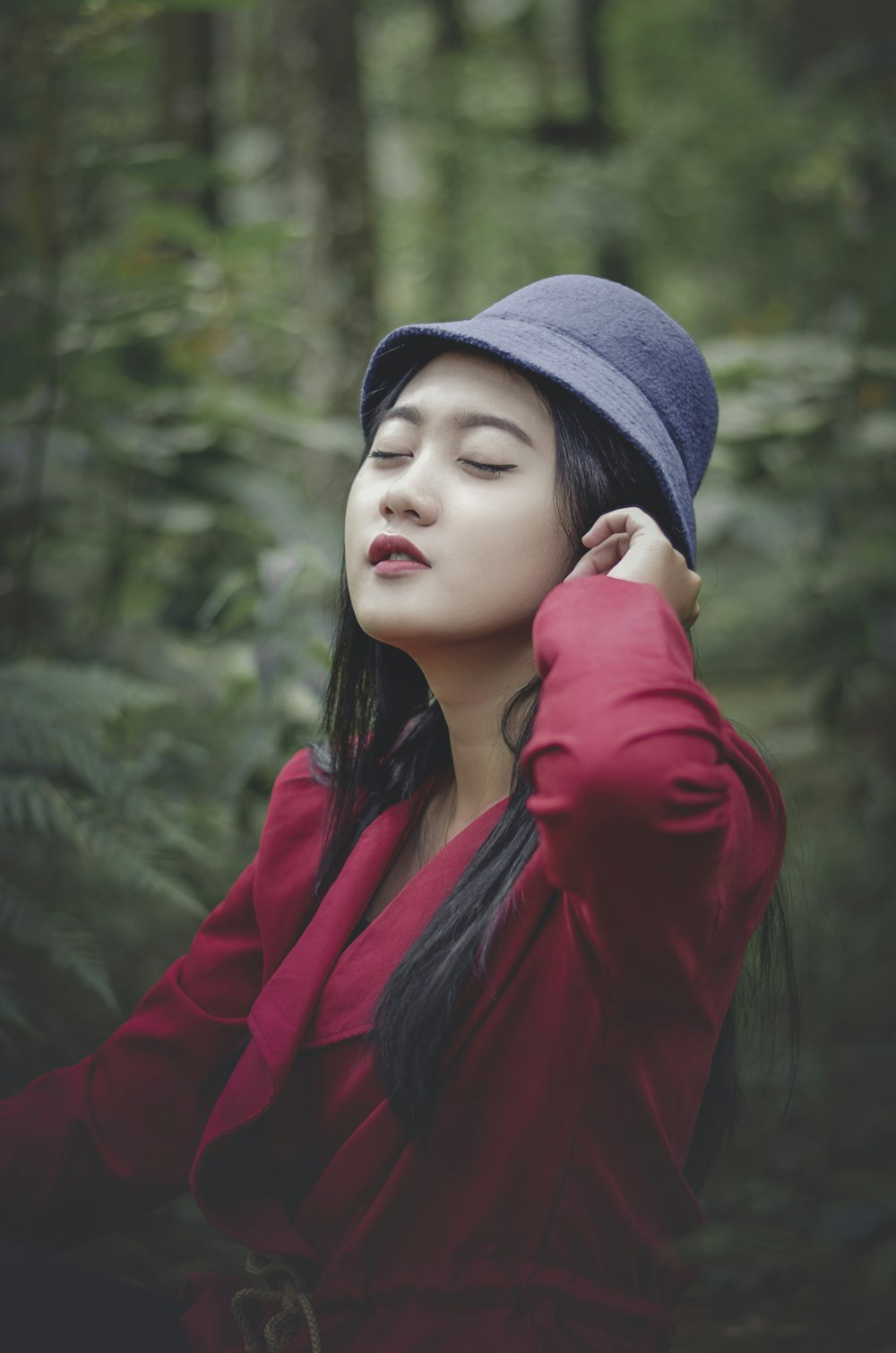 a woman in a red shirt and a blue hat