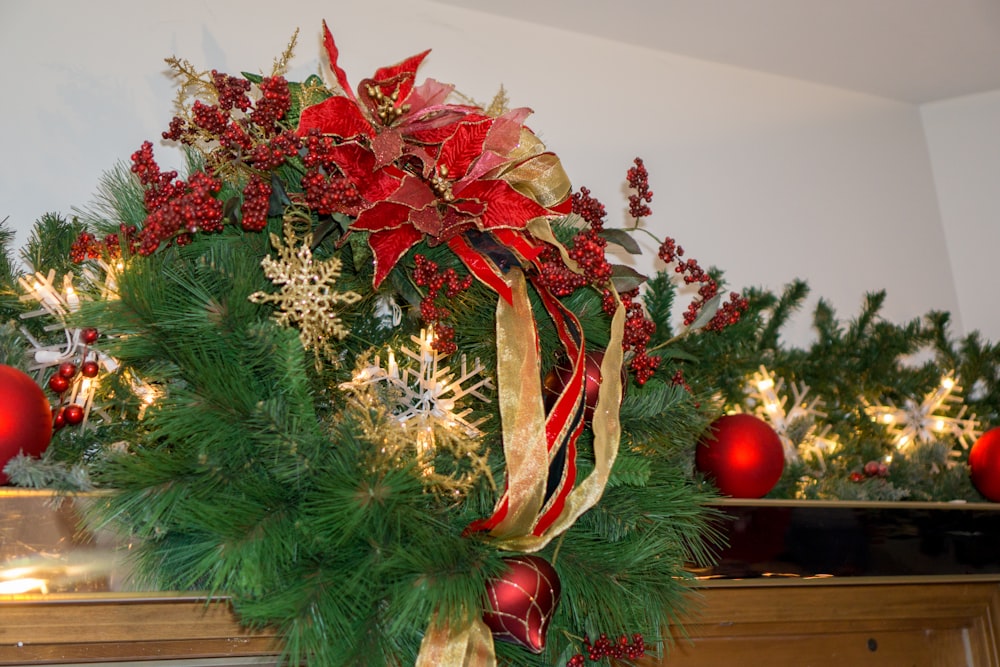 a christmas wreath with red and gold decorations
