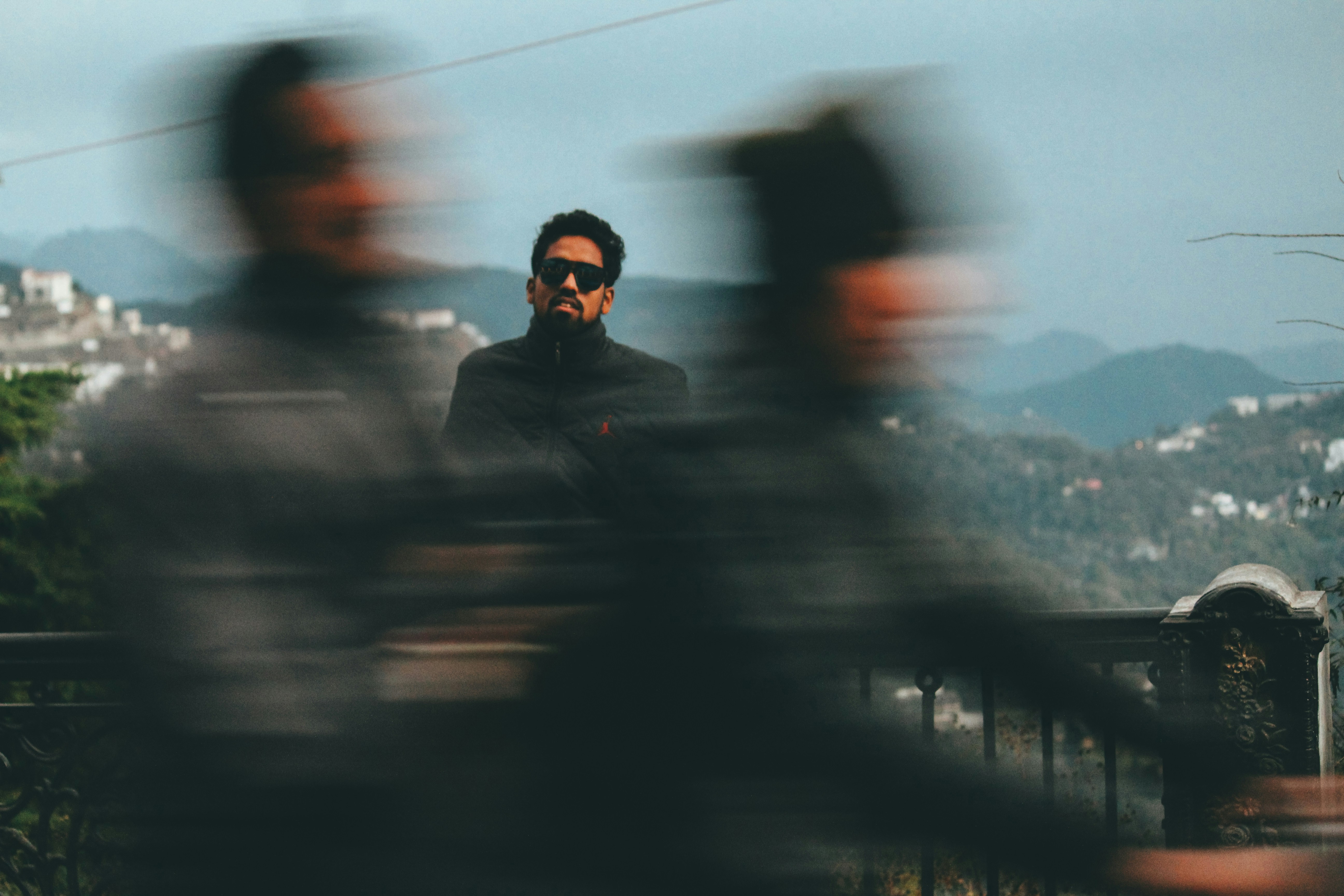 a blurry photo of a man sitting on a bench