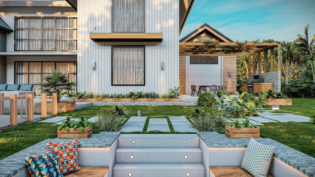 a house with a lot of plants in the front yard,