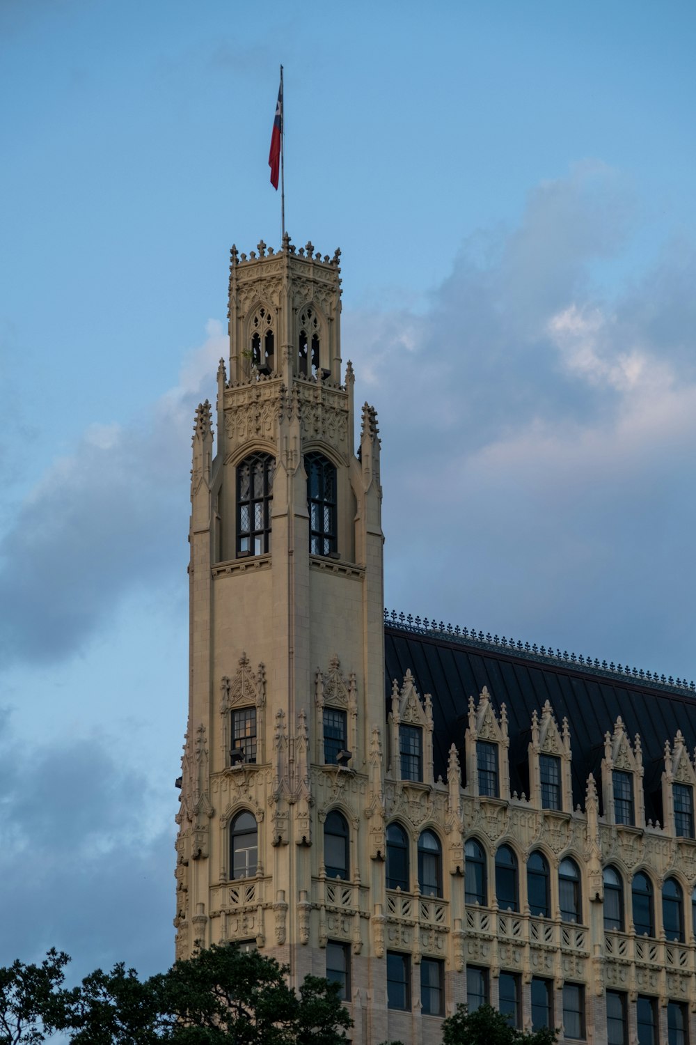 a very tall building with a flag on top of it