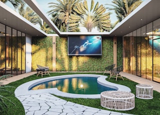 a backyard with a pool and a television