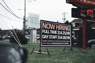 a sign in the grass advertising a job fair