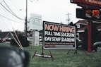 a sign in the grass advertising a job fair