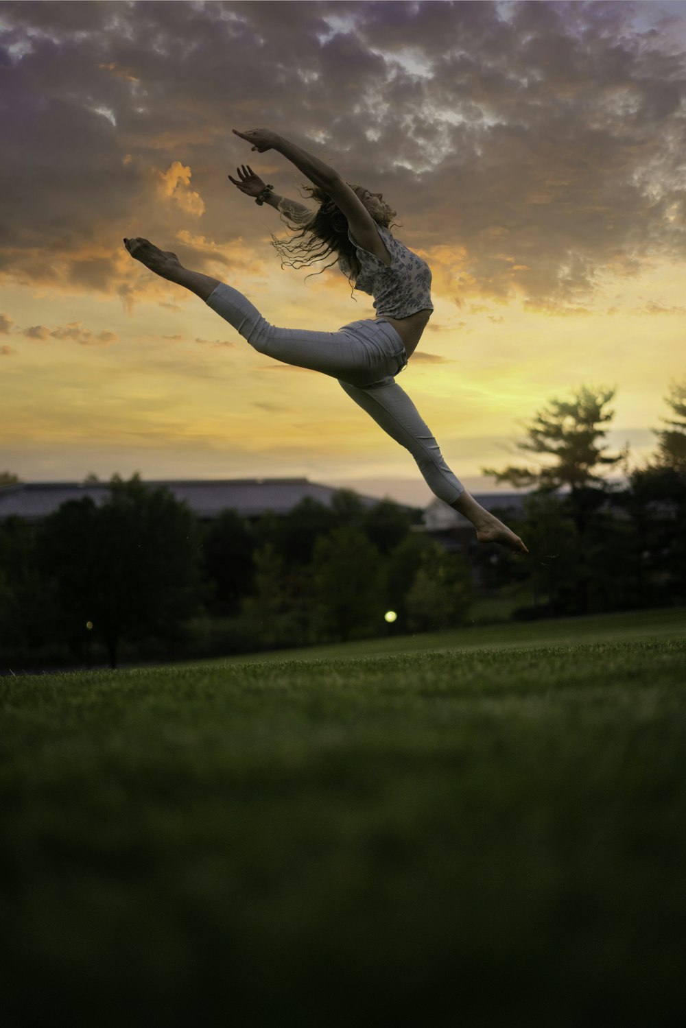 a woman is doing a handstand in a field