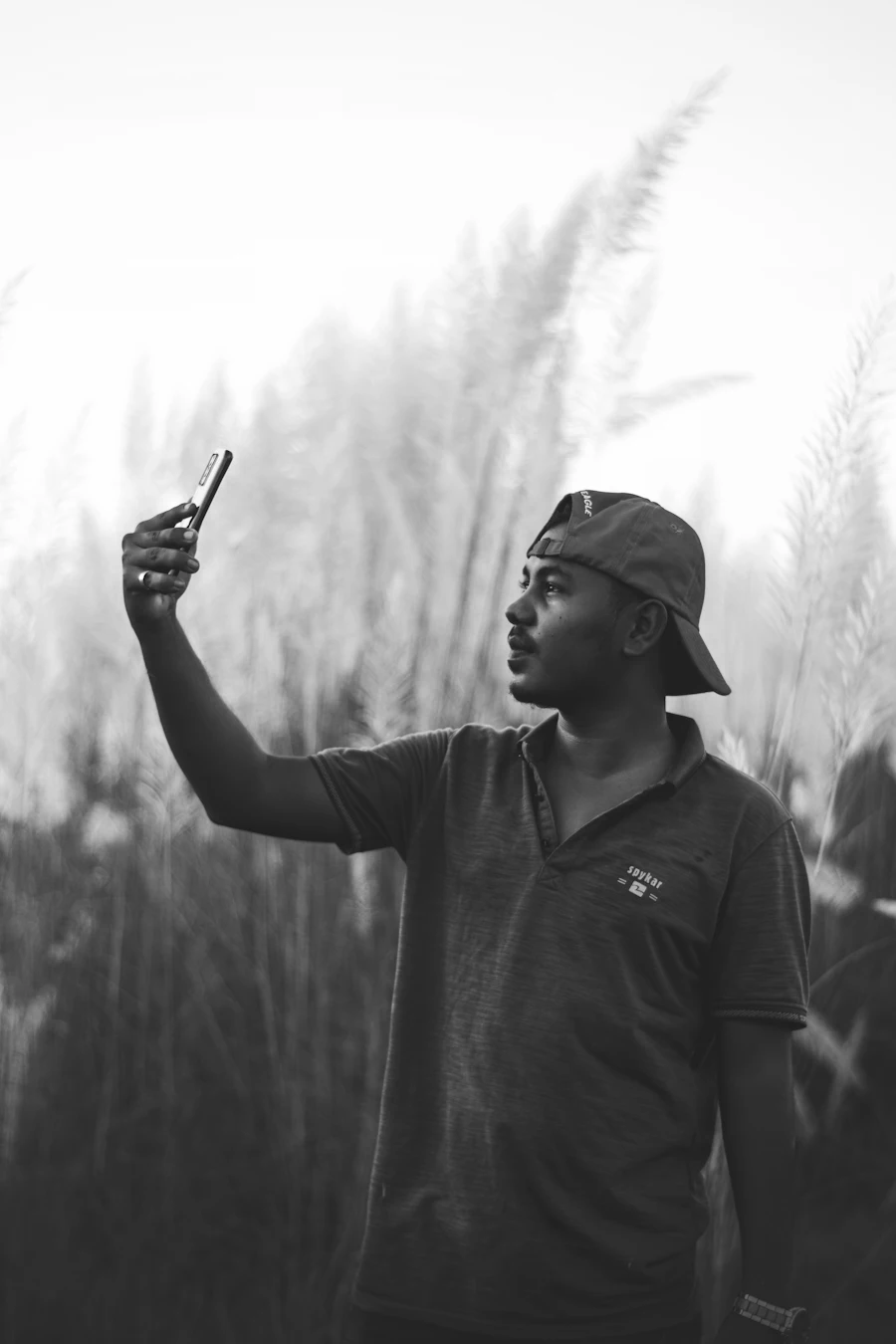 Farmer checking information on a mobile phone in the field