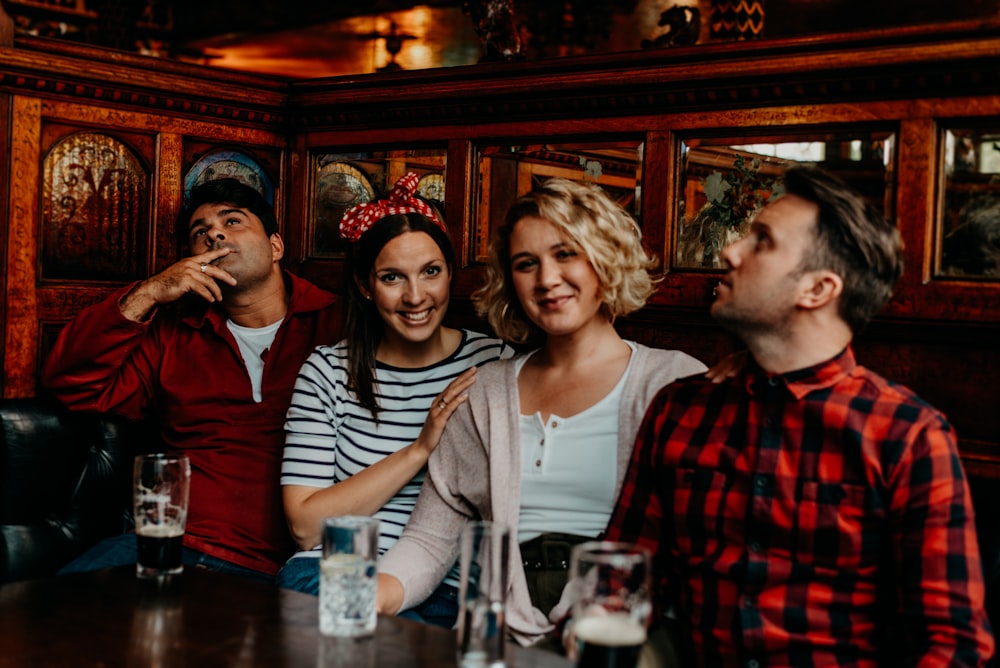 a group of people sitting around a wooden table