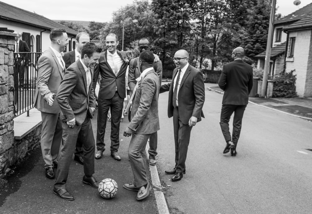 a group of men standing around a soccer ball