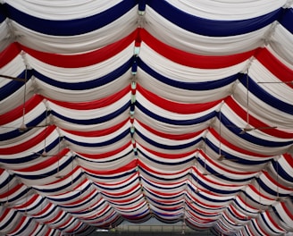 a row of red, white, and blue striped umbrellas