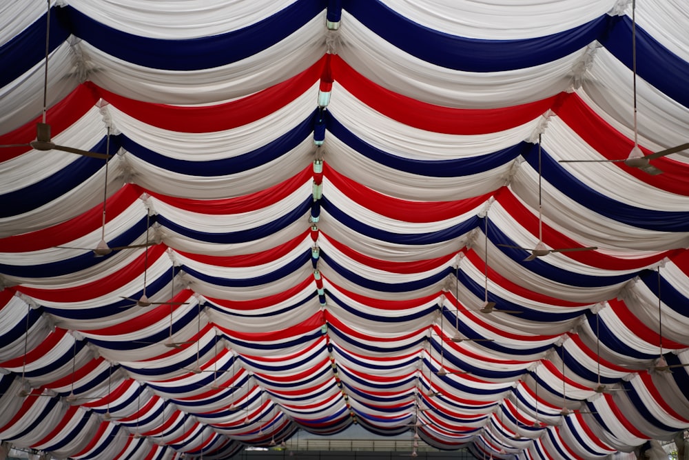 a row of red, white, and blue striped umbrellas