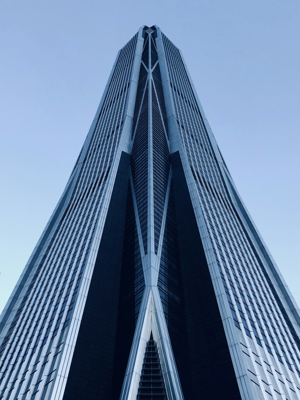 a very tall building with a sky background