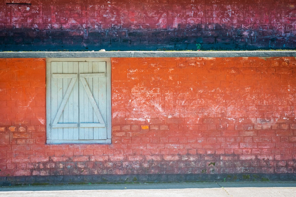 a red brick building with a blue window