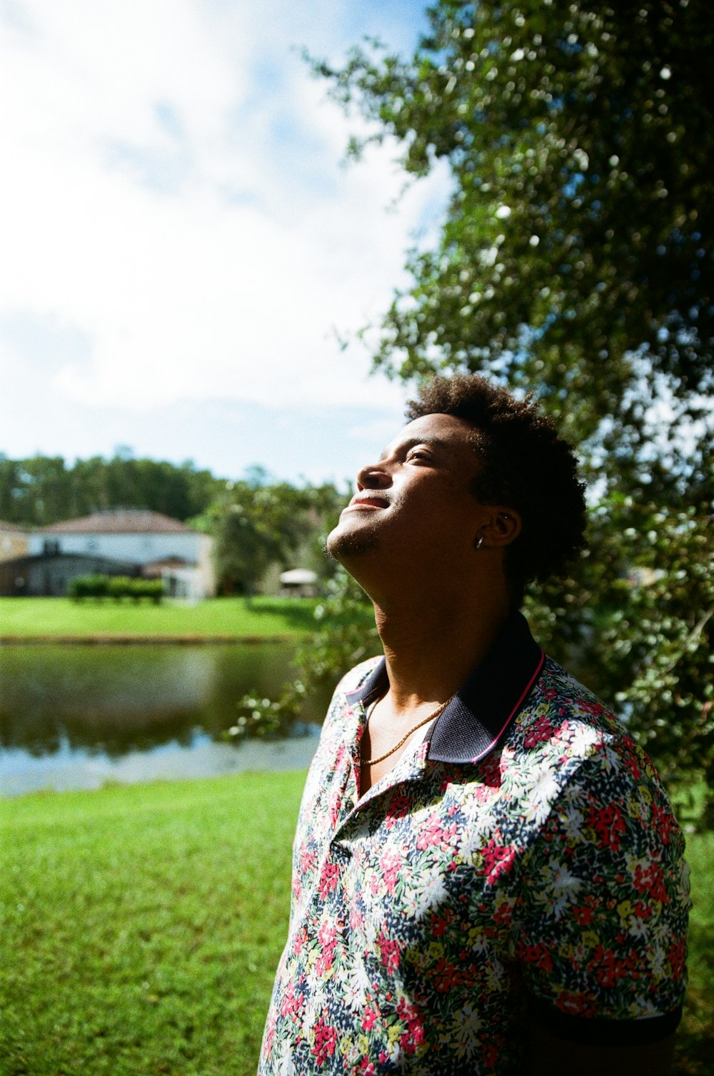 a woman standing in front of a lake looking up