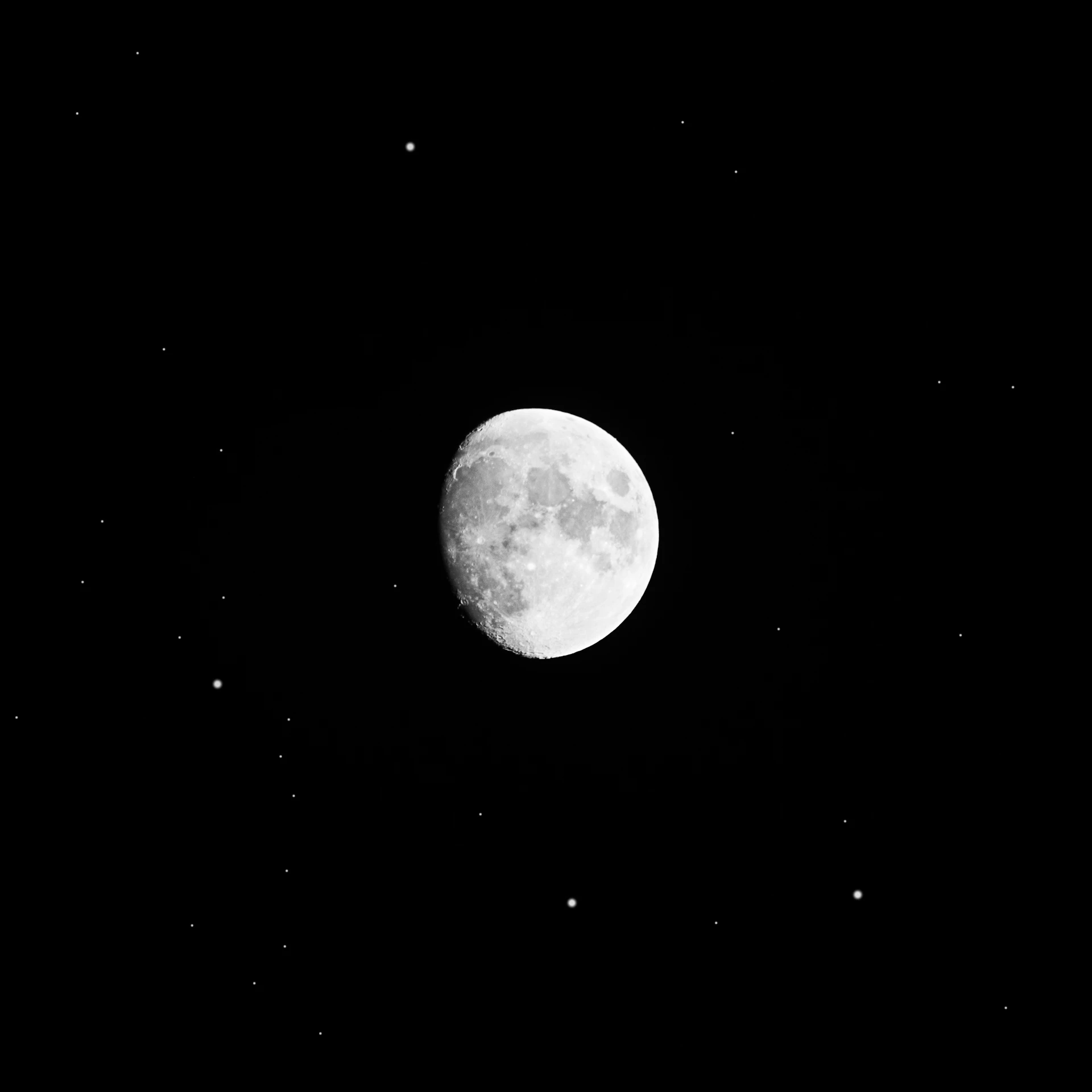 a full moon is seen in the dark sky