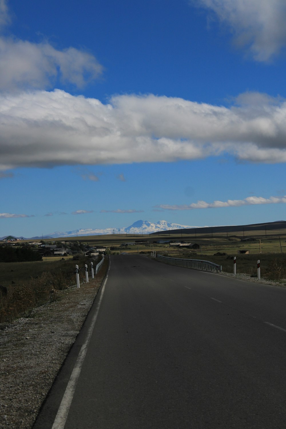 a long empty road with a sky background