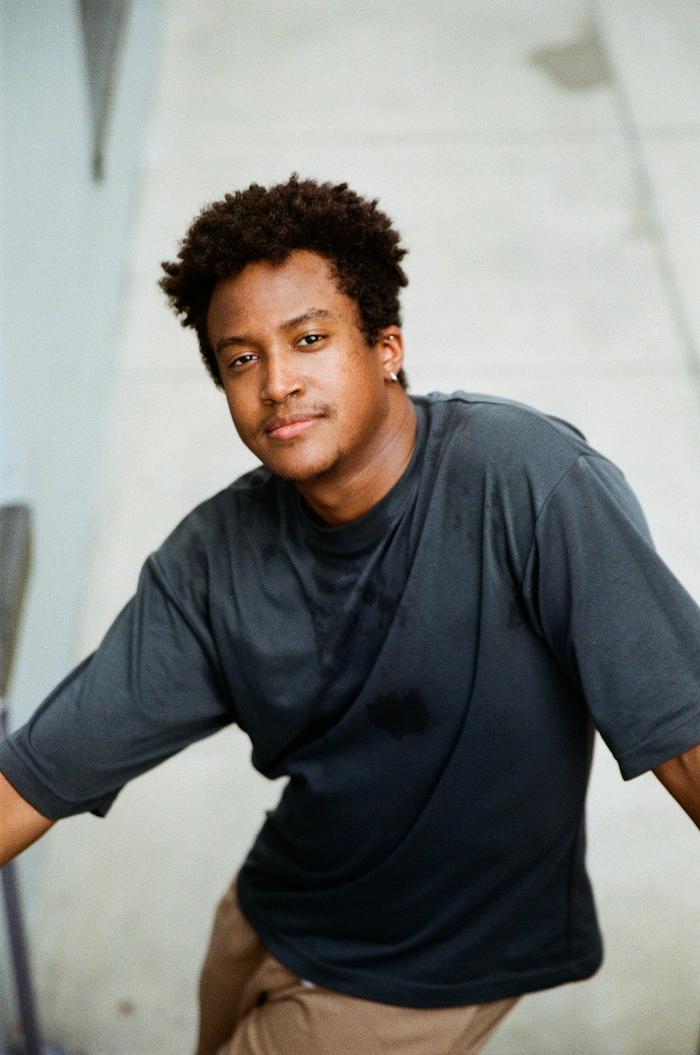 a man in a black shirt is posing for a picture