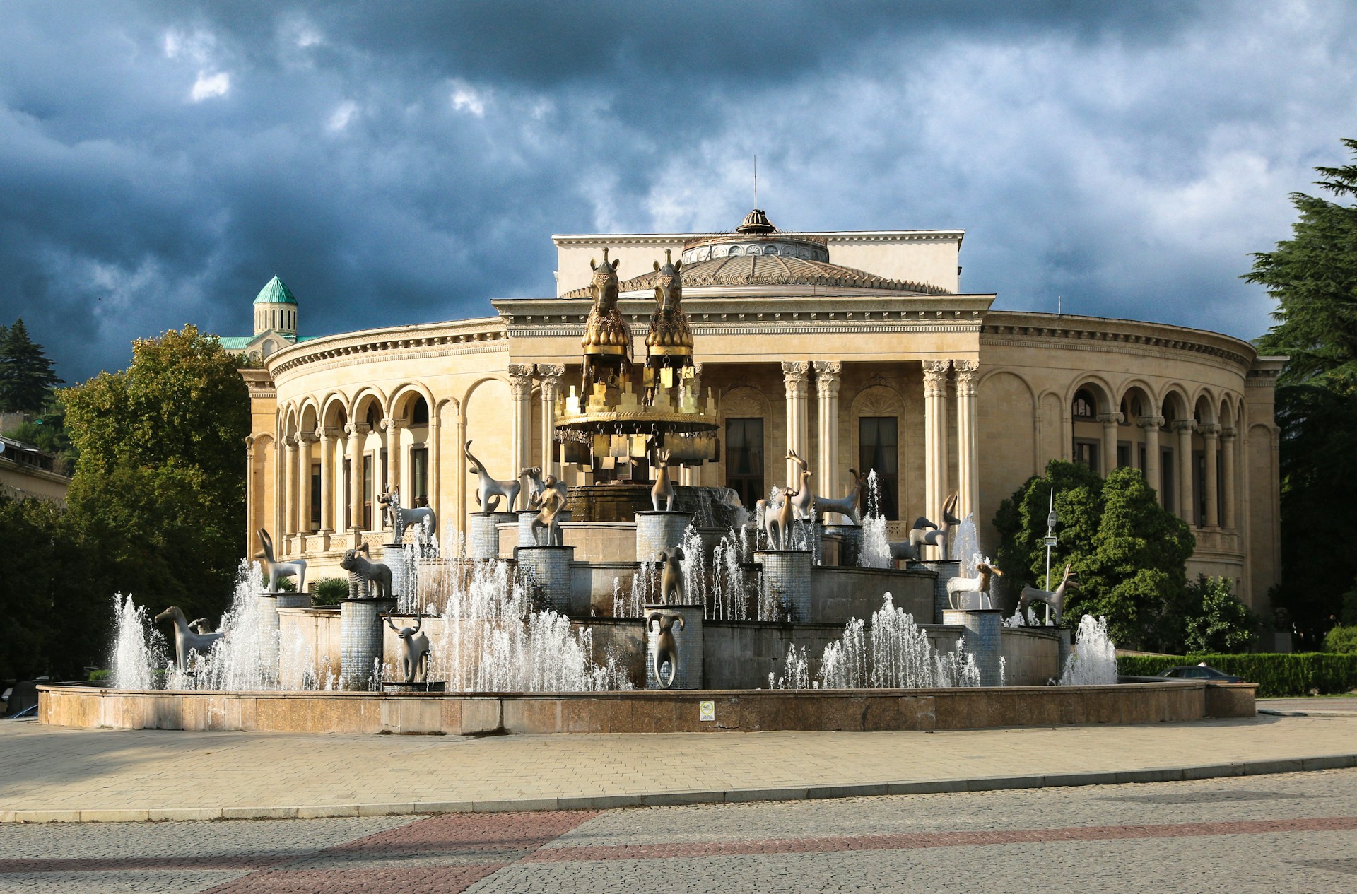 a large building with a fountain in front of it