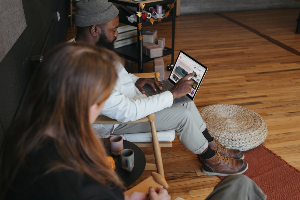 Two people in an office, one person on their Surface laptop