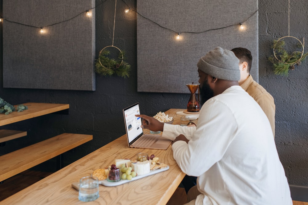 Two people collaborating on their Surface laptop sitting on a table at work 