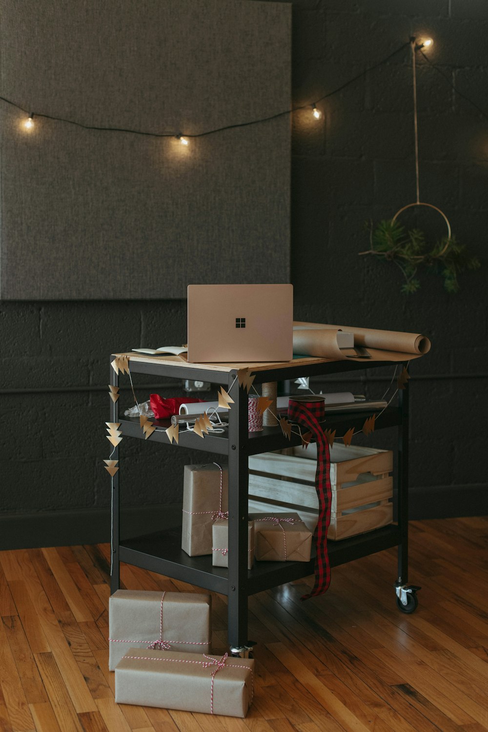 computer sitting on aart with presents and wrapping paper Christmas decorations in the background