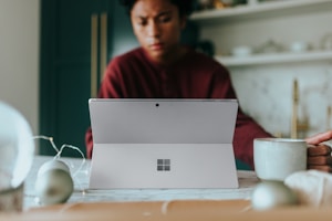 Man on his Surface laptop at home with Christmas decorations around
