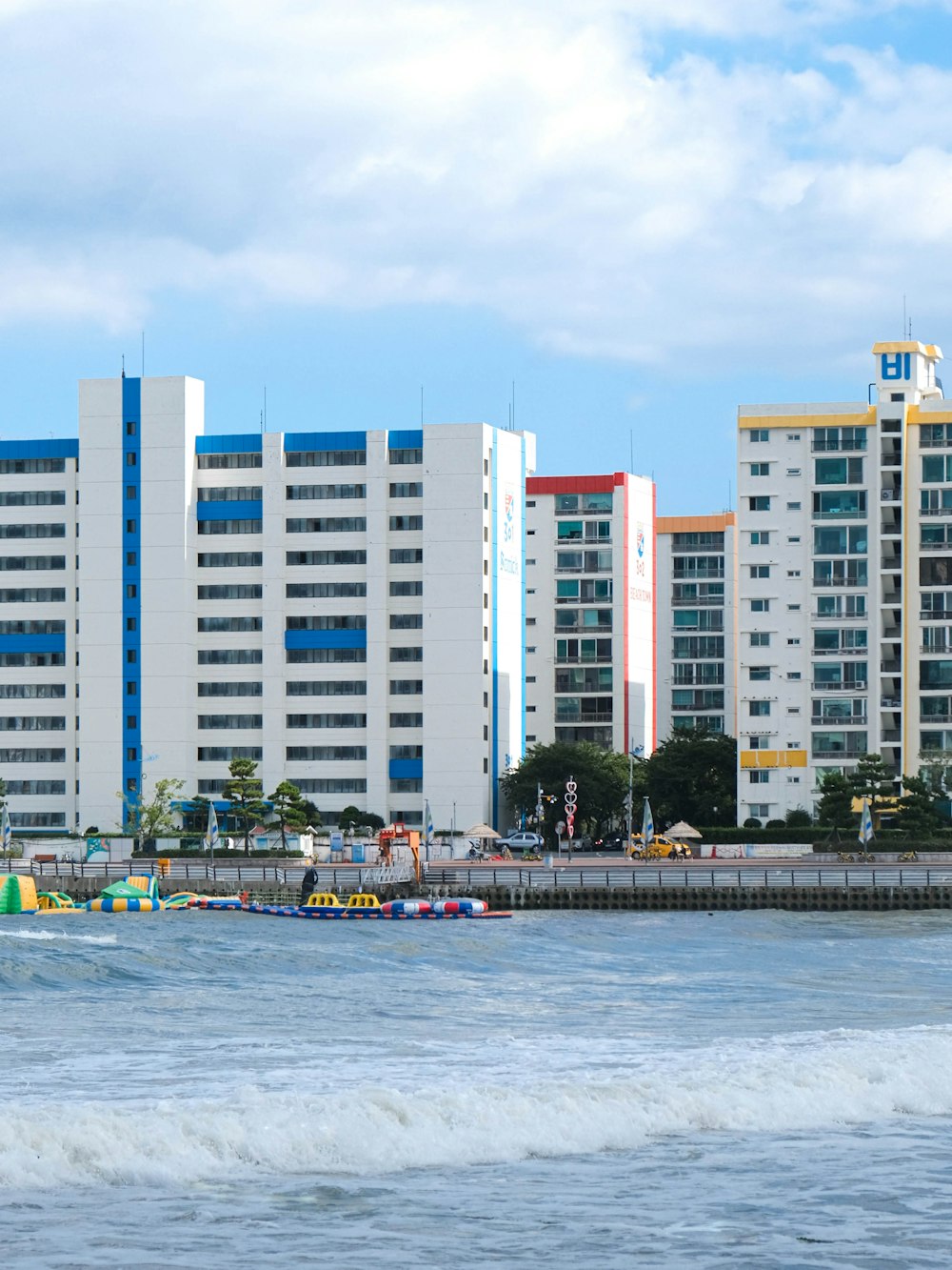 a large white building sitting next to a body of water