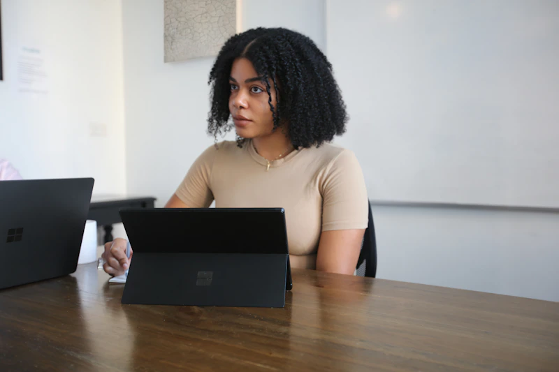 career-focused woman in boardroom with laptop