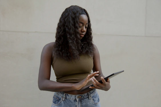 Female typing on her Surface laptop, with a blank wall in the background 