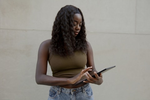 Female typing on her Surface laptop, with a blank wall in the background 