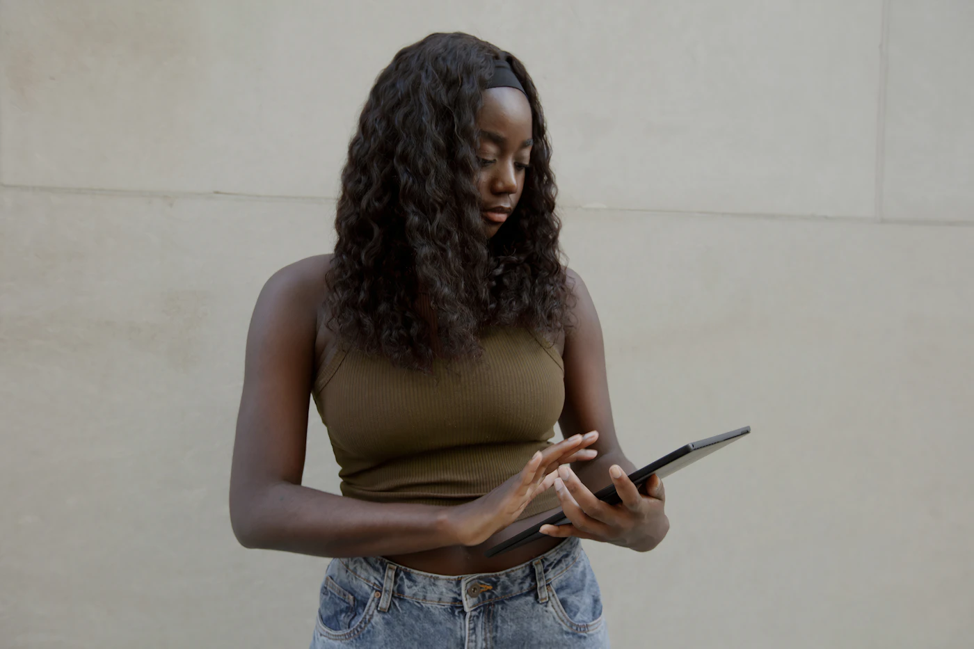 A woman using her tablet on the go