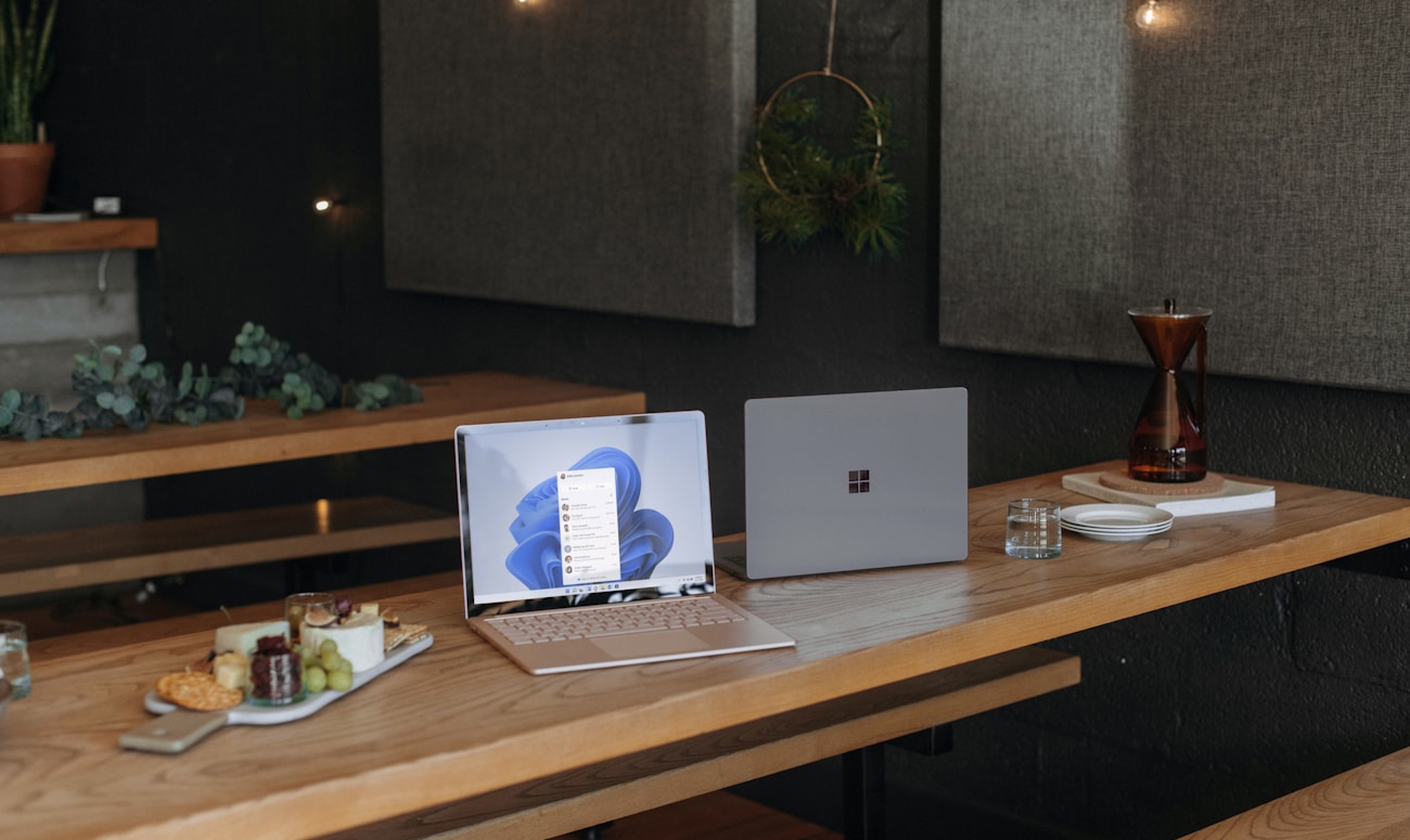 Two Microsoft laptops on a table in an office during the holidays