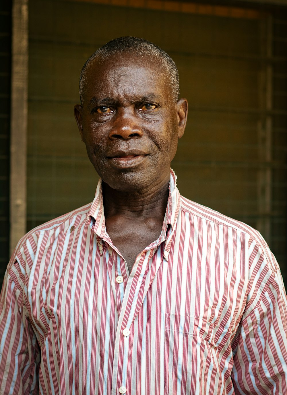 a man wearing a red and white striped shirt