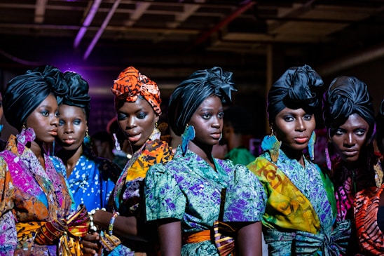 A vibrant fashion photo showcasing stylish outfits on a diverse group of women.