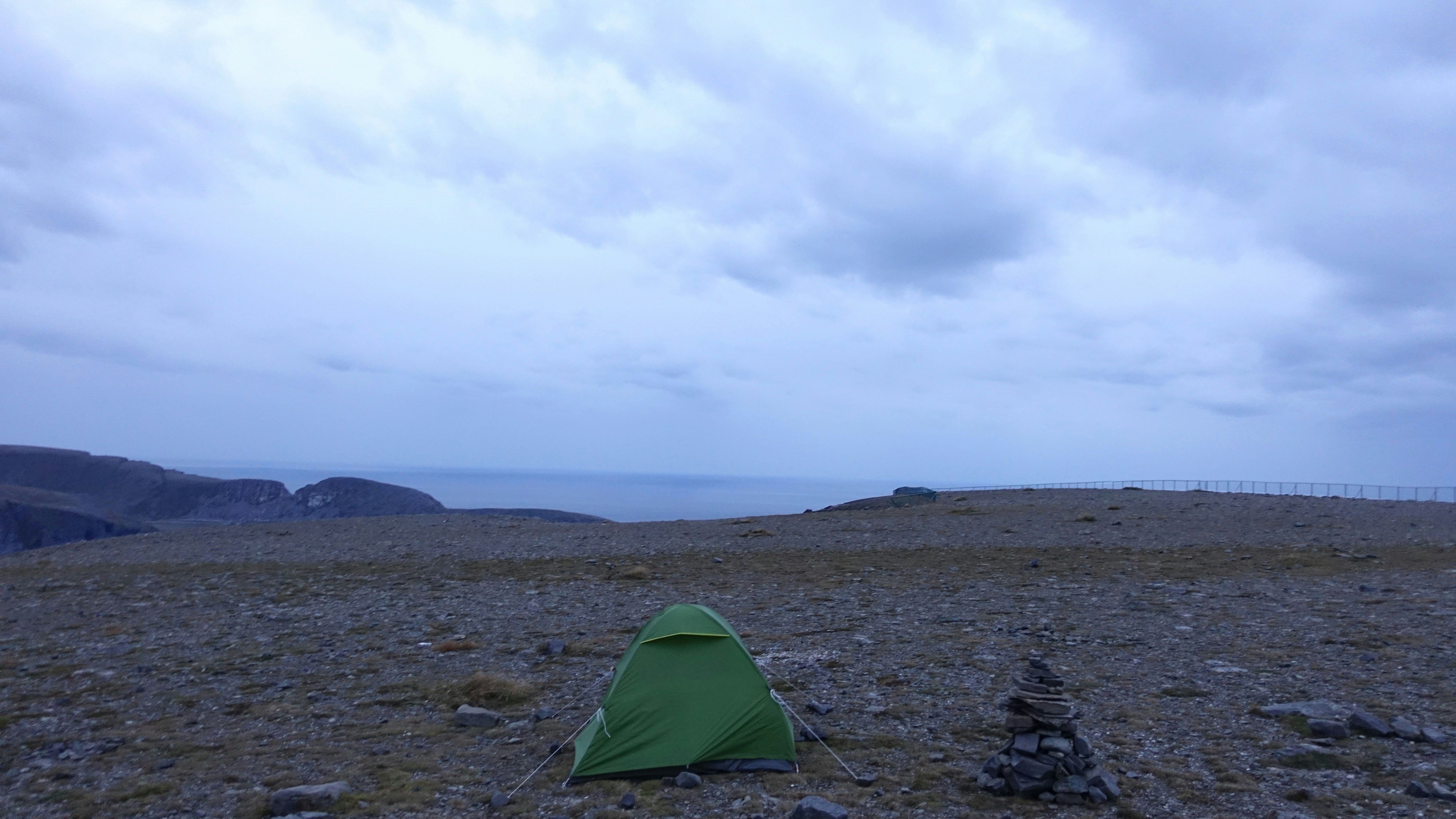 A green tent sitting on top of a rocky field photo – Free Nordkapp ...