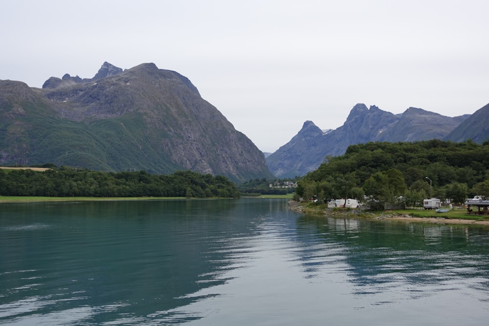 a body of water with mountains in the background