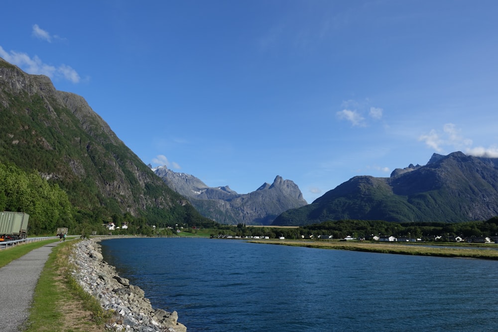 a scenic view of a river with mountains in the background