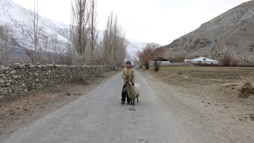 a man riding a horse down a dirt road