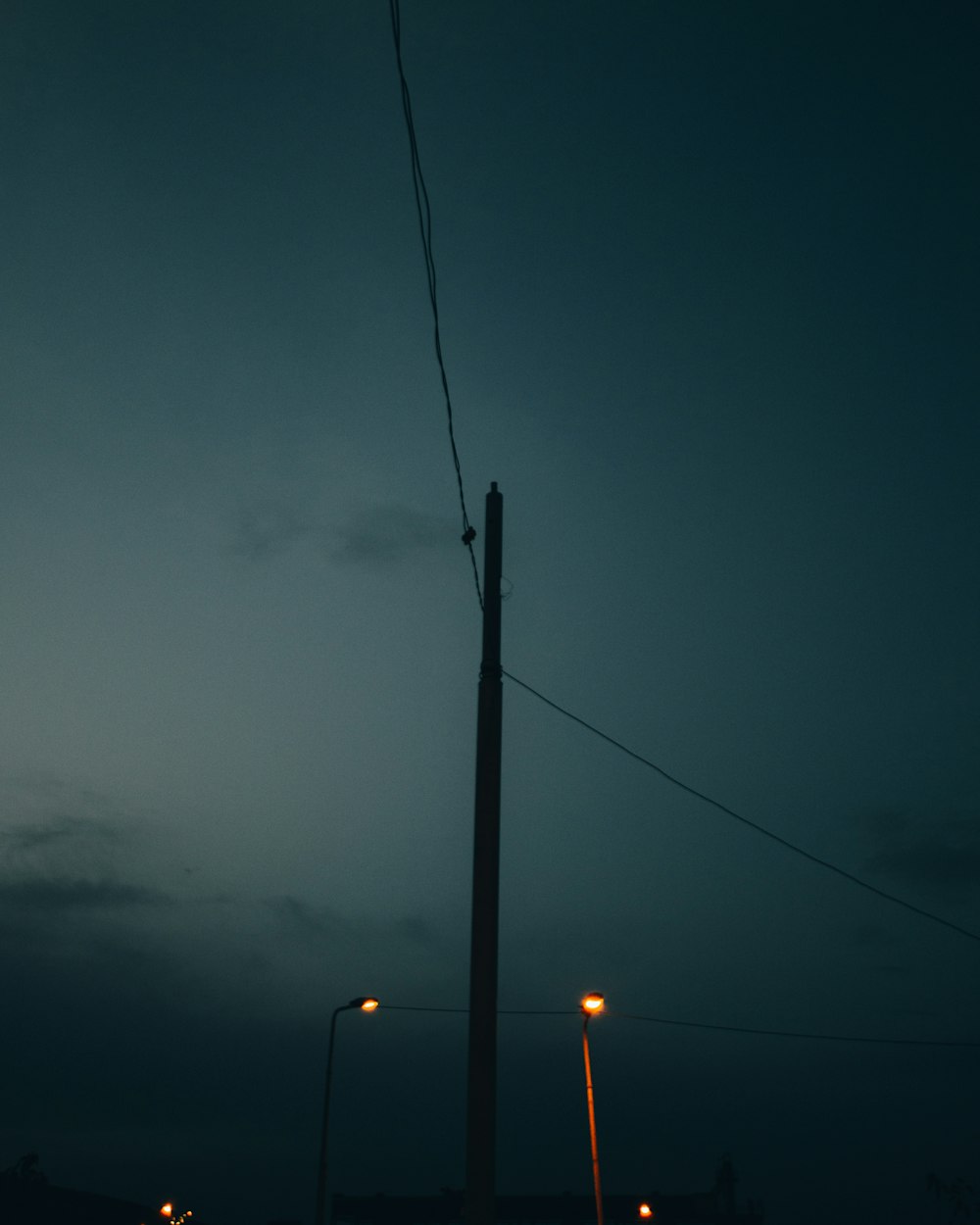 a street light at night with a dark sky in the background