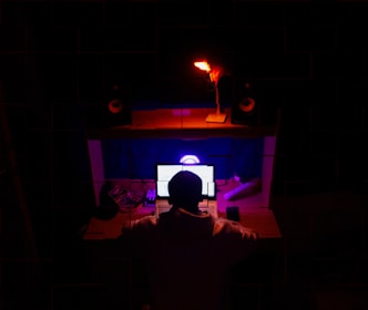 A young professional working from home surrounded by gadgets.