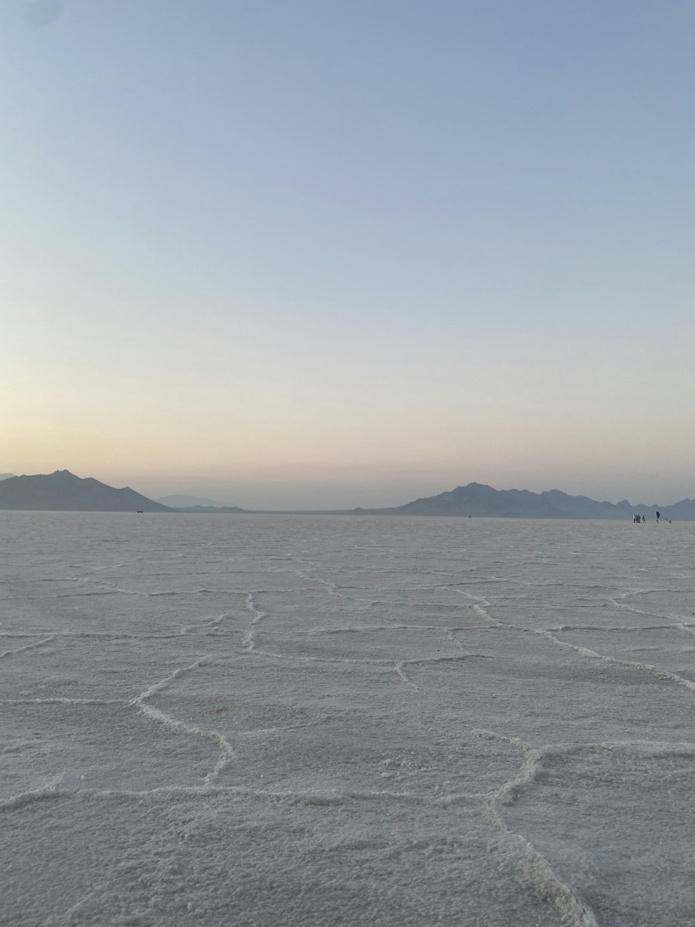 a vast expanse of flat land with mountains in the distance