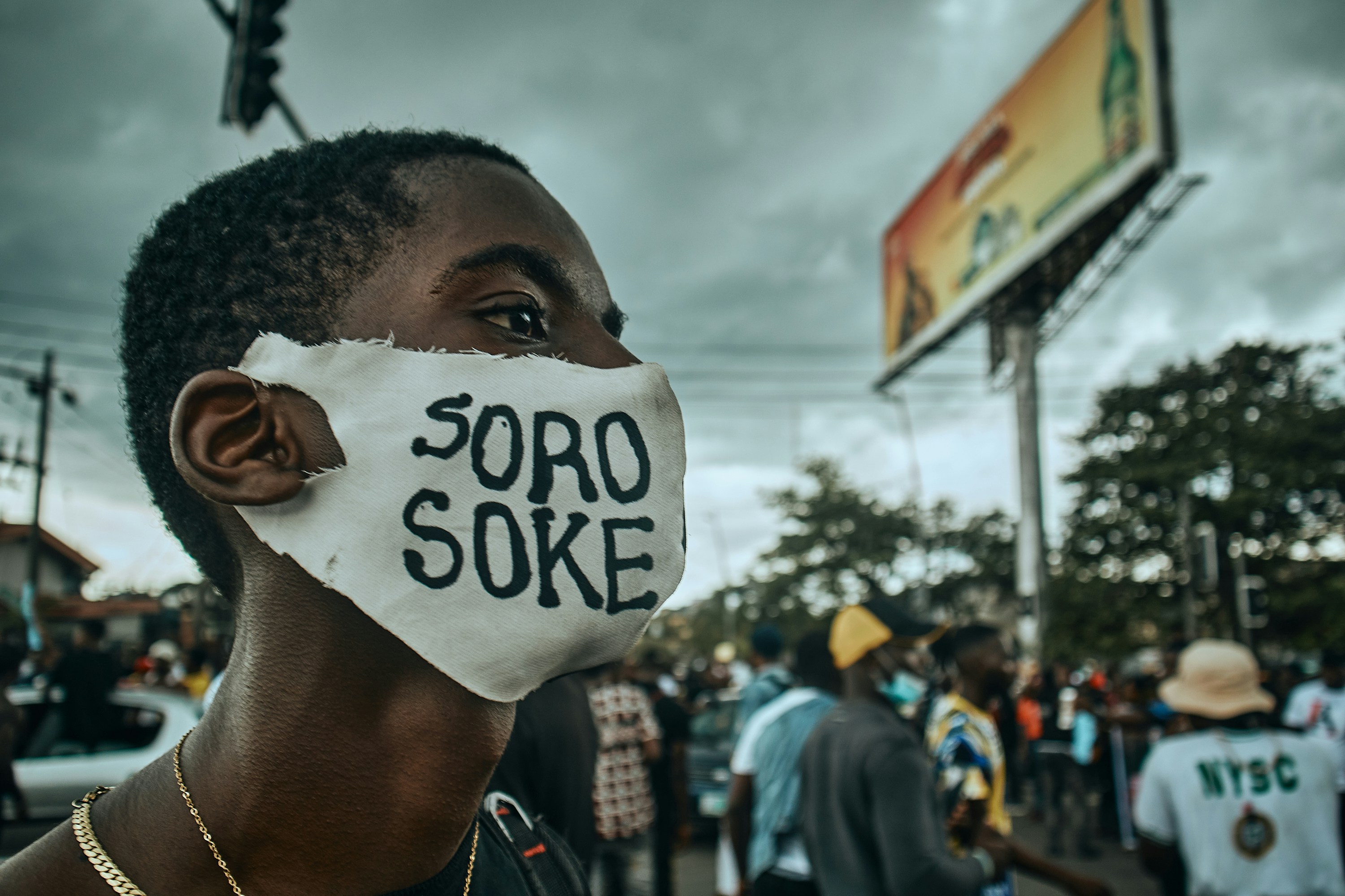 Port Harcourt, Nigeria - October 20, 2020: An #endsars End Sars protester's side view showing a word written on the mask he is wearing. Soro Soke is a Yoruba word that means “Speak Up!” It was very popular during the protest.