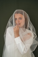 a woman in a veil is posing for a picture