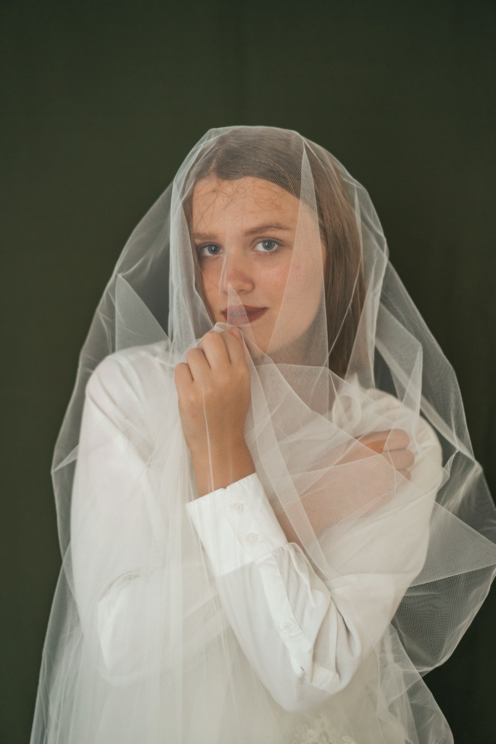 a woman in a veil is posing for a picture