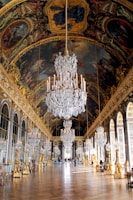a chandelier hanging from the ceiling of a palace