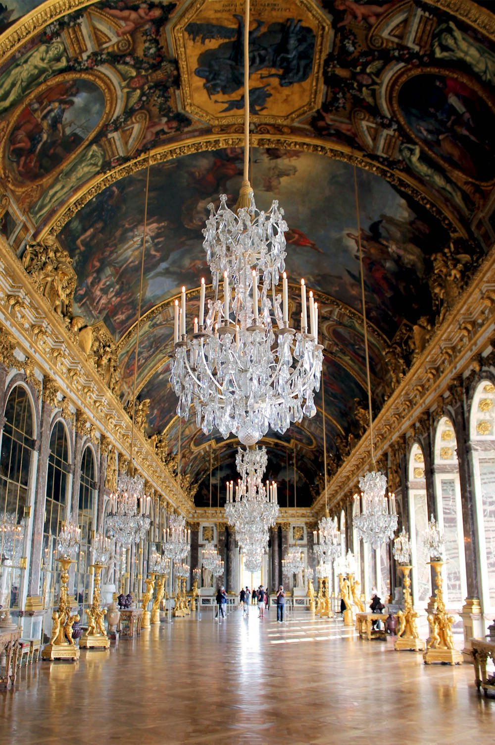 a chandelier hanging from the ceiling of a palace